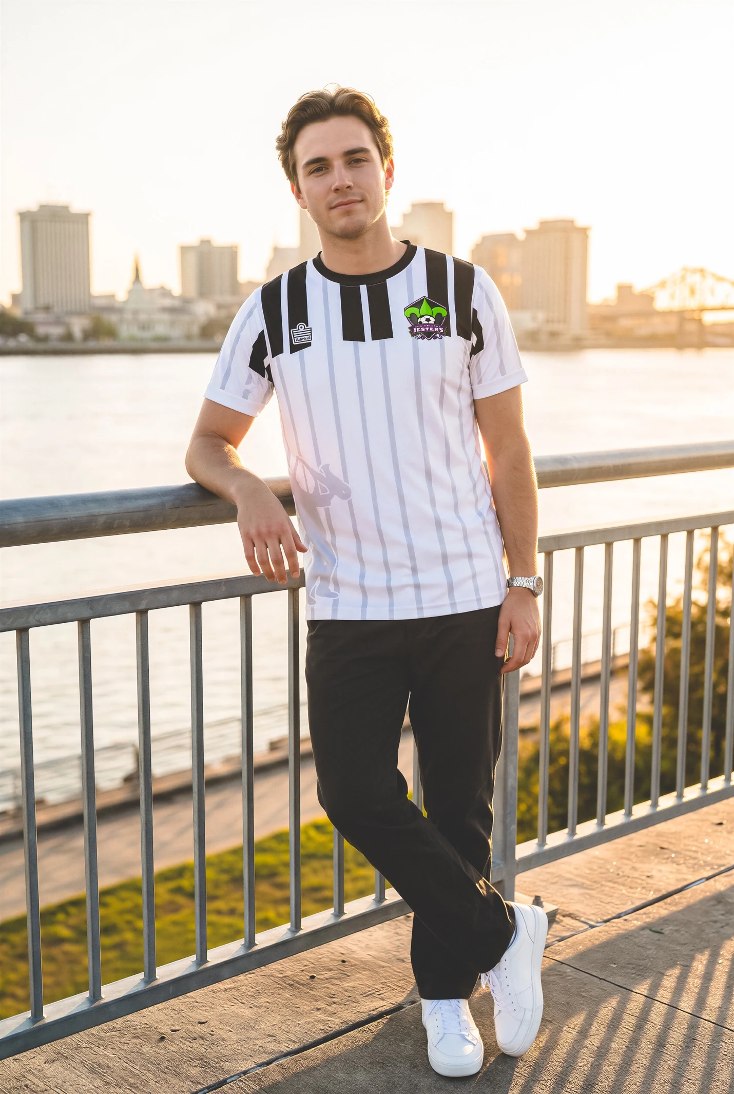A player wearing the white piano-inspired Jesters away shirt by the river
